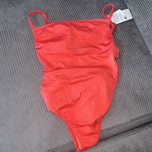 NWT Coral one piece bathing suit, cut out back. Size M fits like a Small